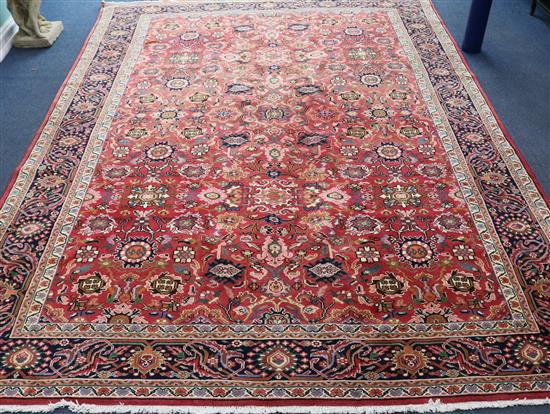 A Persian red ground carpet 11ft 4in by 8ft 3in.